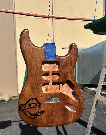 Finished hand stained electric guitar body with a custom engraved logo